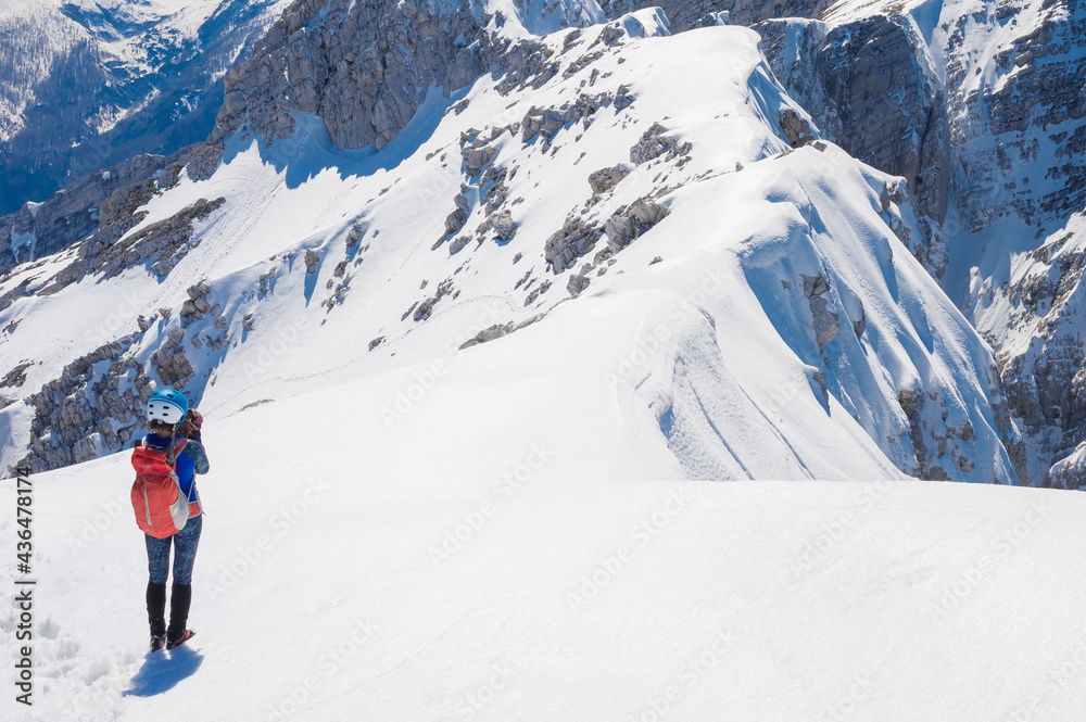 slender positive smiling girl climber mountaineer on a snowy alpine slope slender positive smiling girl climber mountaineer on a snowy alpine slope