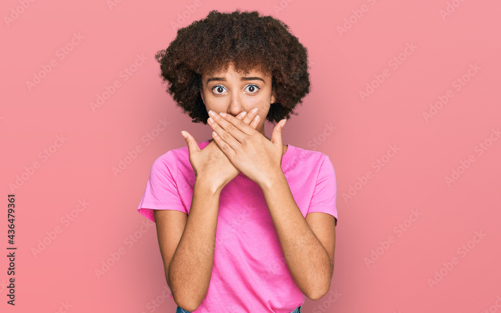 Young hispanic girl wearing casual clothes shocked covering mouth with hands for mistake. secret concept. Young hispanic girl wearing casual clothes shocked covering mouth with hands for mistake. secret concept.
