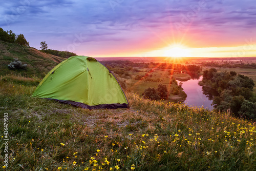 tourist tent on the hill near the river