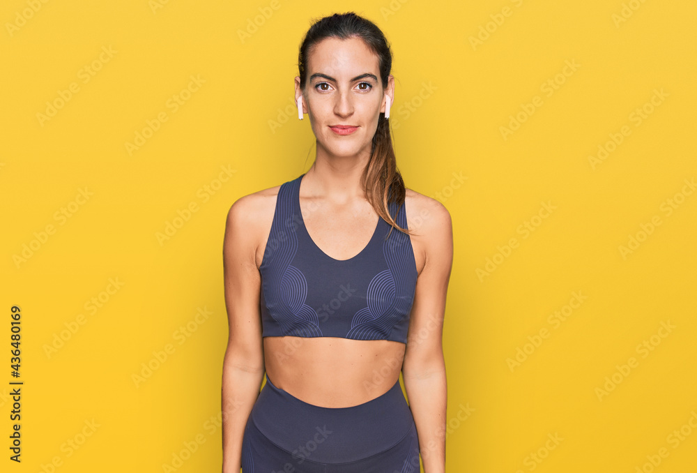 Young beautiful woman wearing sportswear with serious expression on face. simple and natural looking at the camera.