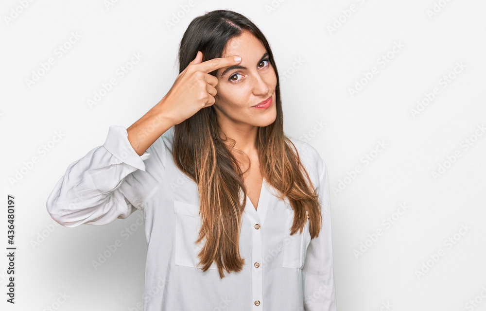 Young beautiful woman wearing casual clothes pointing unhappy to pimple on forehead, ugly infection of blackhead. acne and skin problem Young beautiful woman wearing casual clothes pointing unhappy to pimple on forehead, ugly infection of blackhead. acne and skin problem