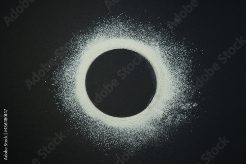 Flour in the form of a circle on a black background