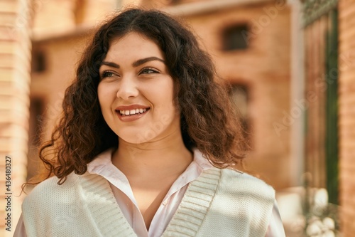 Young hispanic woman smiling happy standing at the city.