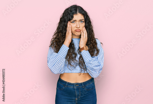 Young hispanic girl wearing casual clothes tired hands covering face, depression and sadness, upset and irritated for problem