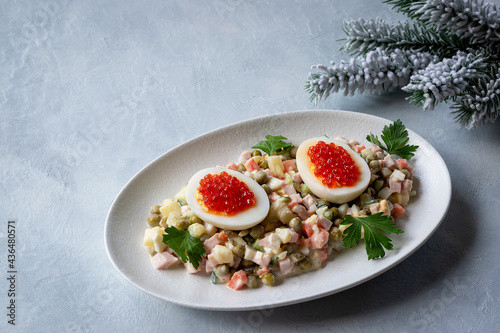 Olivier salad is a traditional Russian dish seasoned with mayonnaise, an essential attribute of the festive New Year's table and Christmas. Copy space.