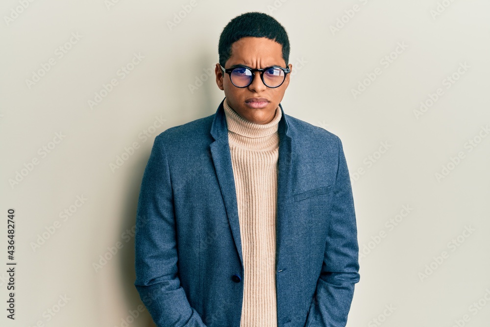 Fototapeta premium Young handsome hispanic man wearing elegant clothes and glasses skeptic and nervous, frowning upset because of problem. negative person.