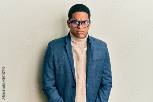 Young handsome hispanic man wearing elegant clothes and glasses skeptic and nervous, frowning upset because of problem. negative person. © Krakenimages.com