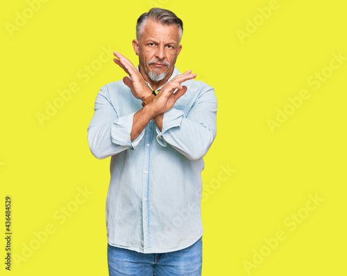 Middle age grey-haired man wearing casual clothes rejection expression crossing arms doing negative sign, angry face