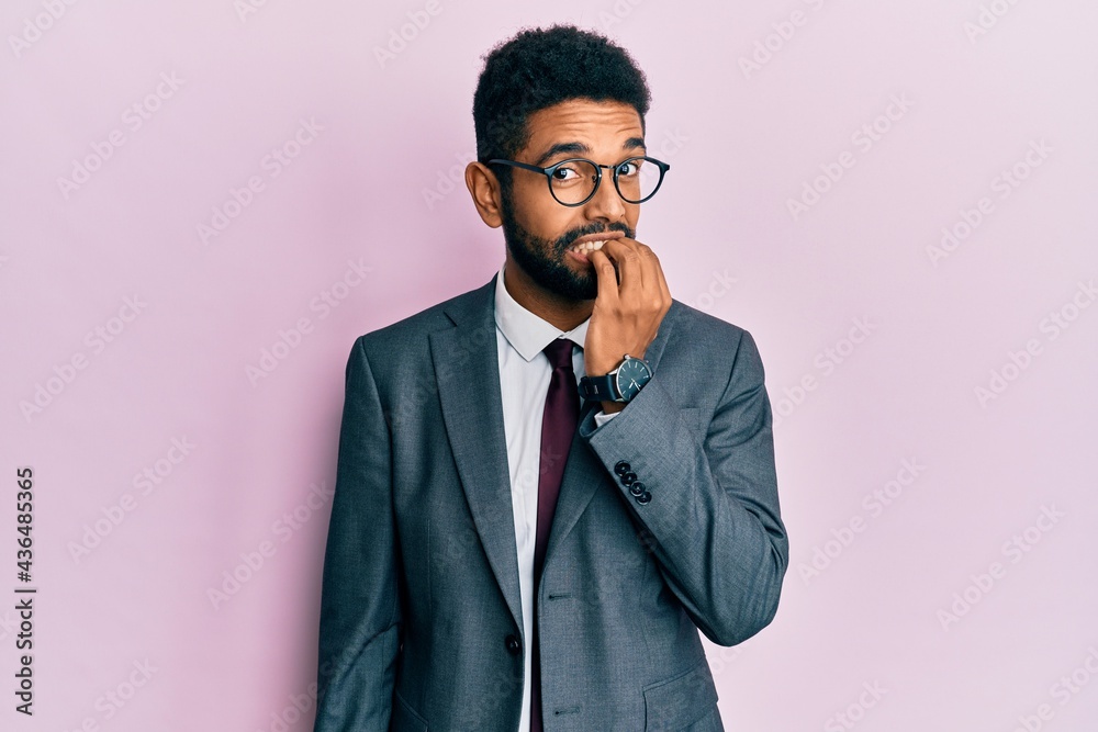 Handsome hispanic business man with beard wearing business suit and tie looking stressed and nervous with hands on mouth biting nails. anxiety problem. Handsome hispanic business man with beard wearing business suit and tie looking stressed and nervous with hands on mouth biting nails. anxiety problem.