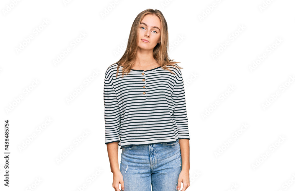Beautiful blonde woman wearing casual clothes relaxed with serious expression on face. simple and natural looking at the camera. Beautiful blonde woman wearing casual clothes relaxed with serious expression on face. simple and natural looking at the camera.