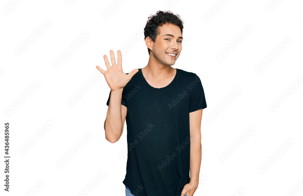 Young handsome man wearing casual black t shirt showing and pointing up with fingers number five while smiling confident and happy. Young handsome man wearing casual black t shirt showing and pointing up with fingers number five while smiling confident and happy.