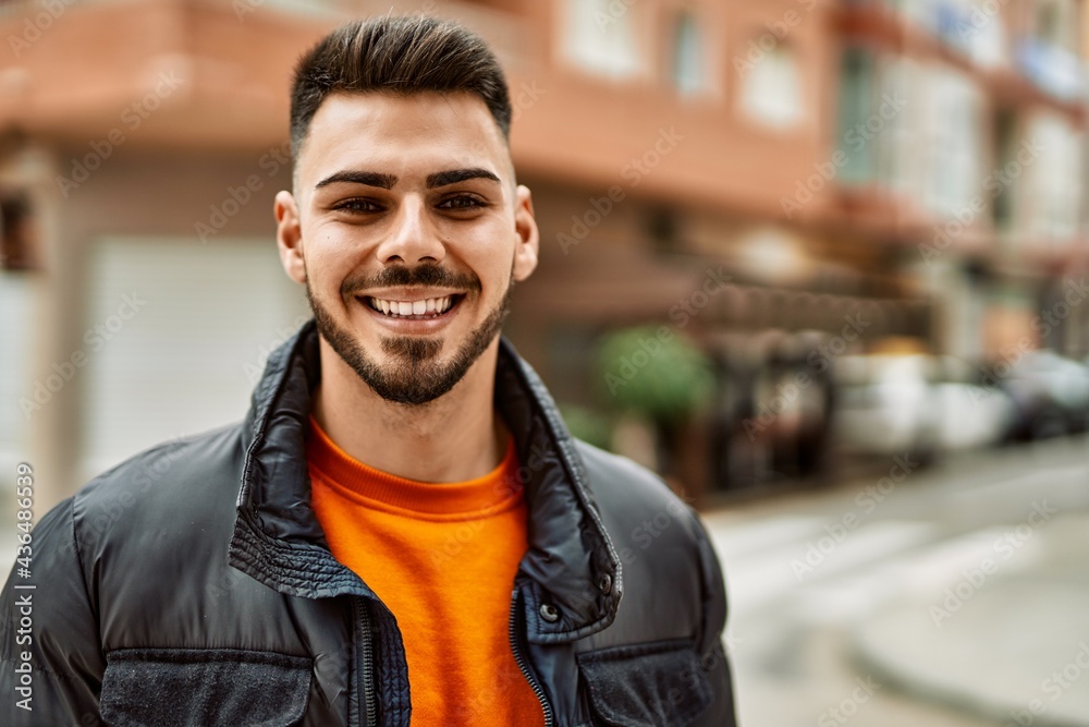 Handsome hispanic man with beard smiling happy and confident at the city wearing winter coat Handsome hispanic man with beard smiling happy and confident at the city wearing winter coat
