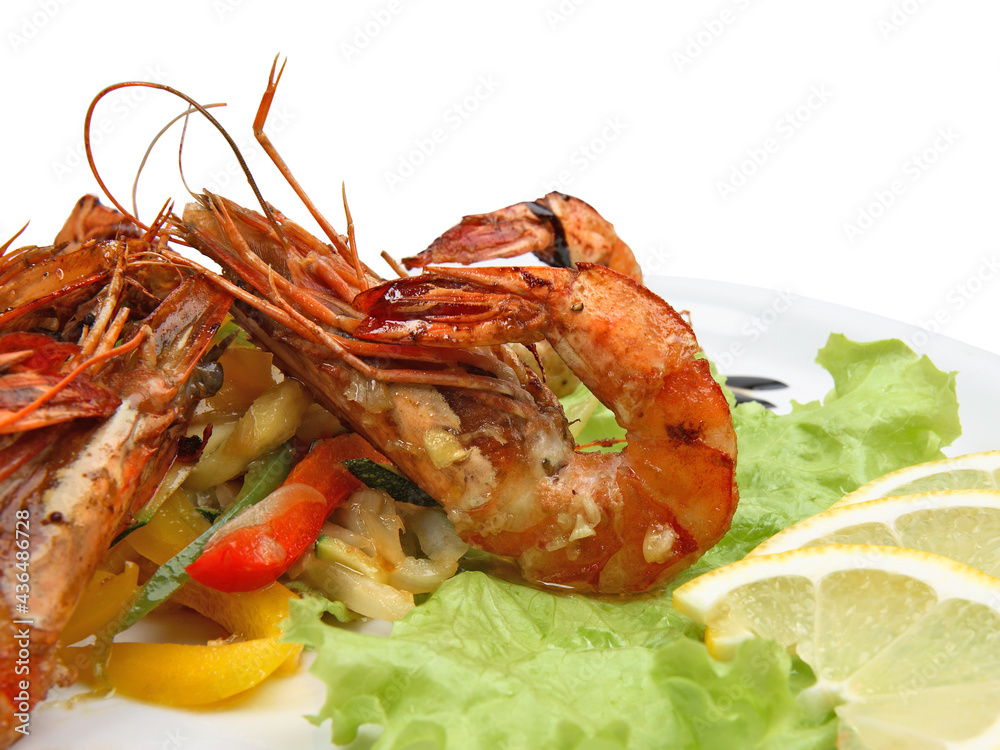 Spicy shrimps with lemon and lettuce on white background Spicy shrimps with lemon and lettuce on white background