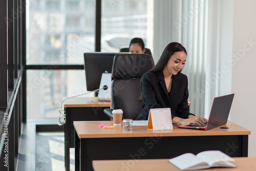 Portrait of young smiling businesswoman working in the office