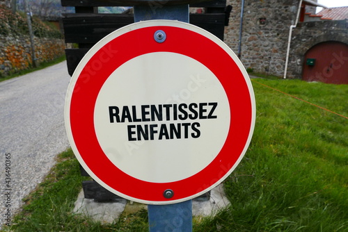 Slow down sign for cars on country road France