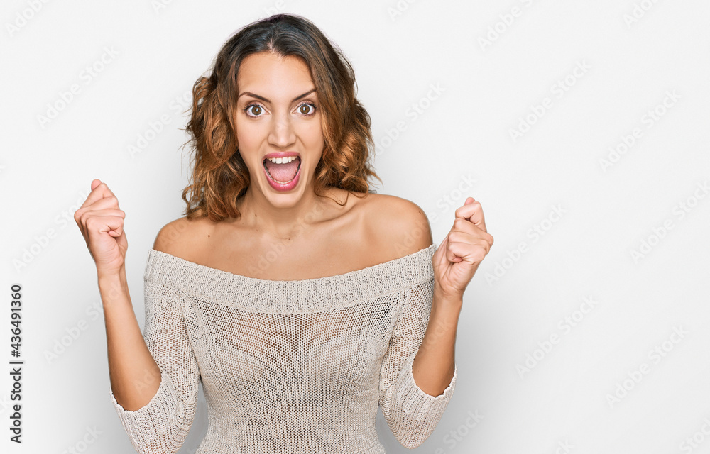Beautiful young caucasian woman wearing casual clothes celebrating surprised and amazed for success with arms raised and open eyes. winner concept. Beautiful young caucasian woman wearing casual clothes celebrating surprised and amazed for success with arms raised and open eyes. winner concept.