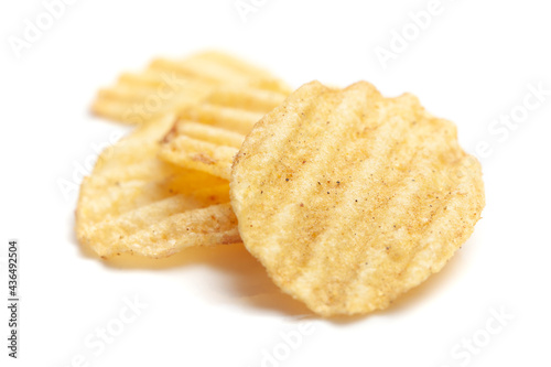 Close up of Wrinkled Wavy Potato Chips, Popular Ready to eat crunchy, salty pale-yellow color over white background