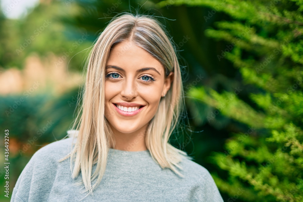 Young blonde girl smiling happy standing at the park. Young blonde girl smiling happy standing at the park.