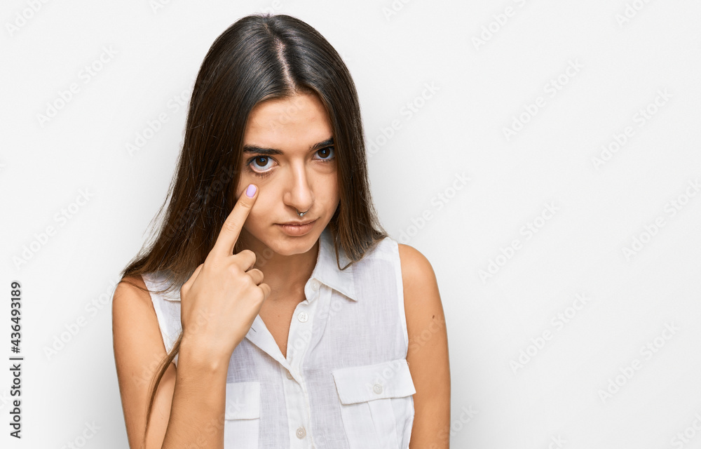 Young hispanic woman wearing casual clothes pointing to the eye watching you gesture, suspicious expression Young hispanic woman wearing casual clothes pointing to the eye watching you gesture, suspicious expression