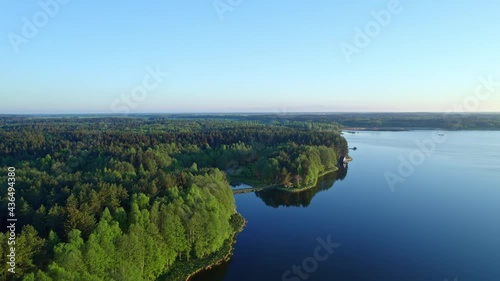 aerial drone footage of lakefront houseboat, vacation house cabin on a pine forest lake with a pond and blue water dock,
lakeside vacation home,
Riverside cabin. spring landscape. 4K 59.94 fps