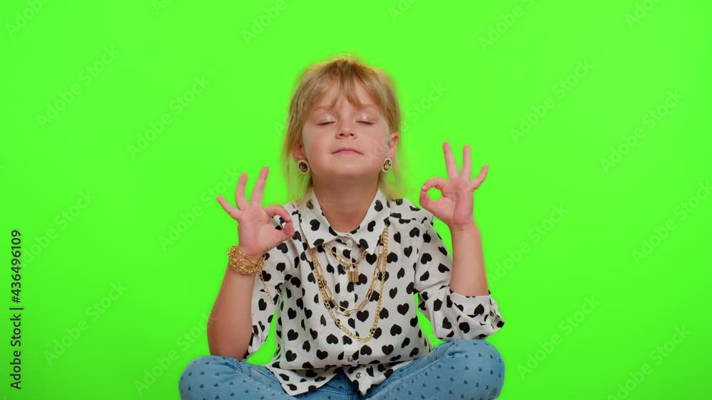 Meditating with concentrated thoughts. Keep calm down, relax, inner balance. Child kid girl breathes deeply with mudra gesture, eyes closed, peaceful mind. Young children on chroma key background. Meditating with concentrated thoughts. Keep calm down, relax, inner balance. Child kid girl breathes deeply with mudra gesture, eyes closed, peaceful mind. Young children on chroma key background.