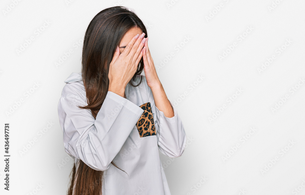 Young hispanic girl wearing casual clothes with sad expression covering face with hands while crying. depression concept. Young hispanic girl wearing casual clothes with sad expression covering face with hands while crying. depression concept.