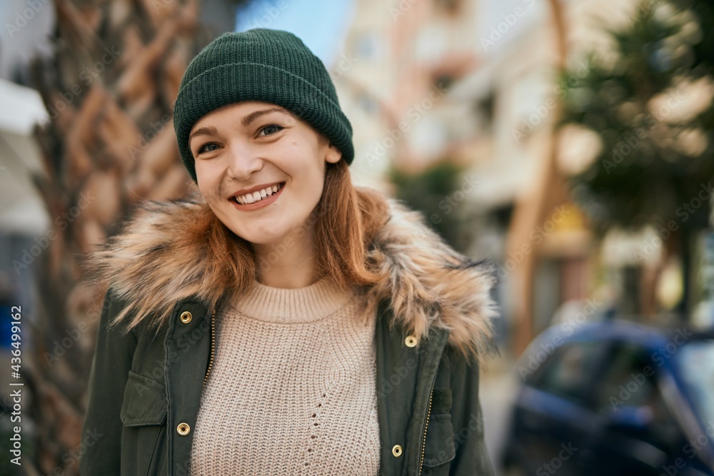 Young caucasian girl smiling happy standing at the city.