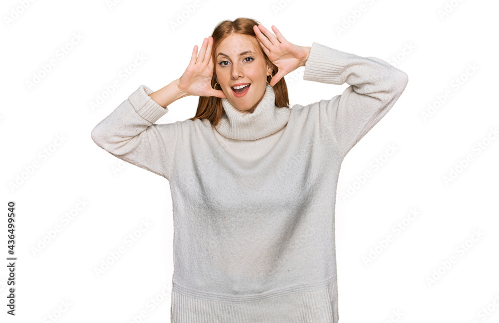 Young irish woman wearing casual winter sweater smiling cheerful playing peek a boo with hands showing face. surprised and exited Young irish woman wearing casual winter sweater smiling cheerful playing peek a boo with hands showing face. surprised and exited