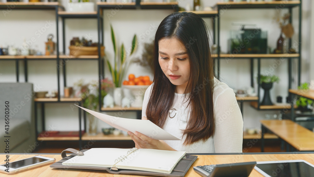 Young asian woman in smart casual wear working in home office. Social distance practice prevent coronavirus COVID-19. Young asian woman in smart casual wear working in home office. Social distance practice prevent coronavirus COVID-19.