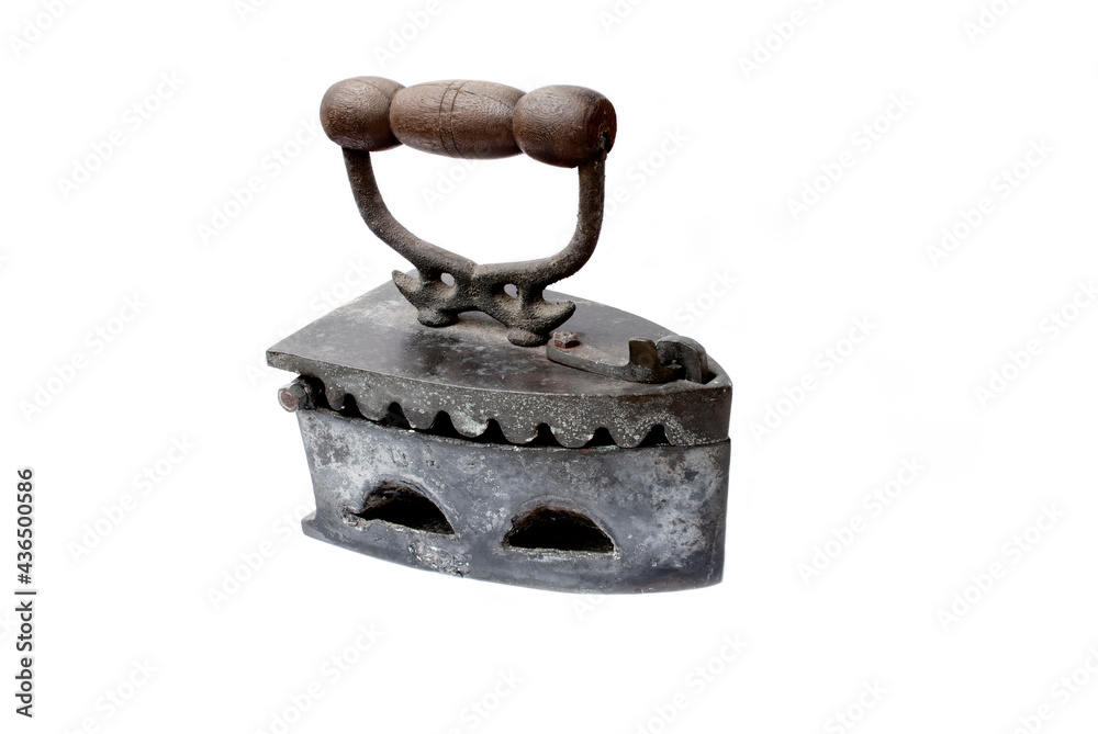 Antique charcoal iron. Wooden handle, oblique to the right.