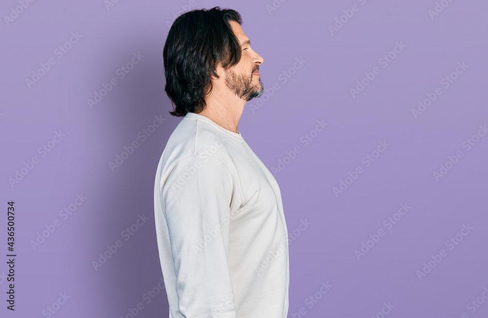 Middle age caucasian man wearing casual clothes looking to side, relax profile pose with natural face and confident smile. Middle age caucasian man wearing casual clothes looking to side, relax profile pose with natural face and confident smile.