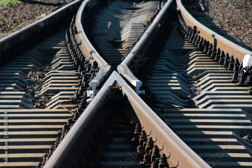 Converging railroad tracks close up on a sunny summer day. Travel, life and business planning concept photo
