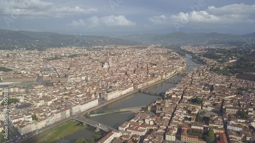 drone flying froward above the florence roofs, rivers and bridges with panoramic view