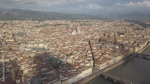 drone flying above the florence roofs, rivers and bridges with panoramic view