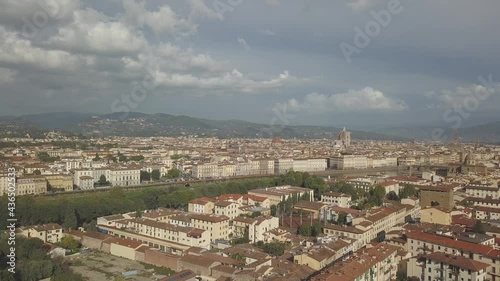 drone flying up above the florence roofs, rivers and bridges with panoramic view