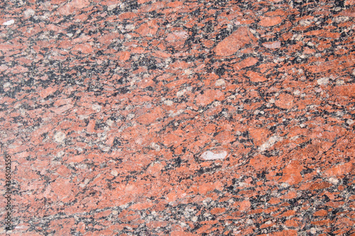 Beautiful texture of red-brown granite stone, background with copy space