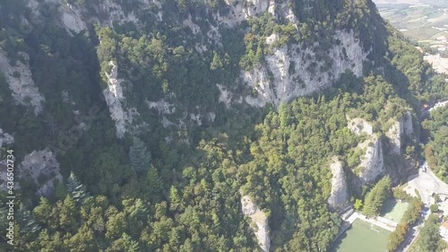 drone flying froward view from down to the san marino towers at the top of the mountain  in Italy