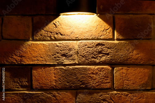 brick wall, illuminated by light from above