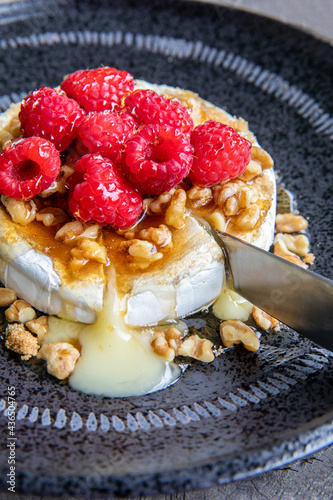 Baked brie with raspberries and walnuts photo