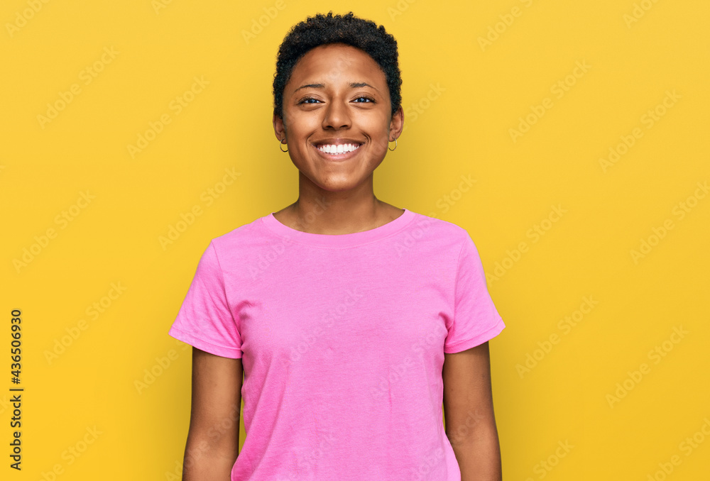 Young african american woman wearing casual clothes with a happy and cool smile on face. lucky person. Young african american woman wearing casual clothes with a happy and cool smile on face. lucky person.