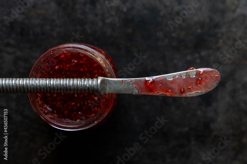 Raspberry jam with knife 