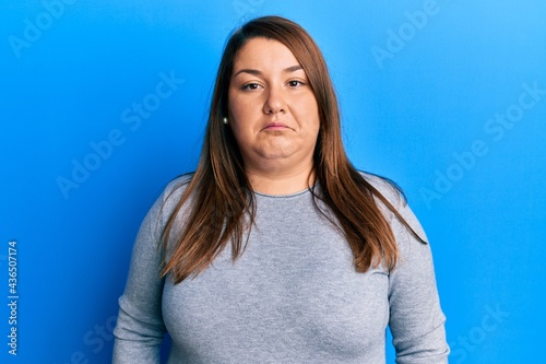 Beautiful brunette plus size woman wearing casual clothes depressed and worry for distress, crying angry and afraid. sad expression.