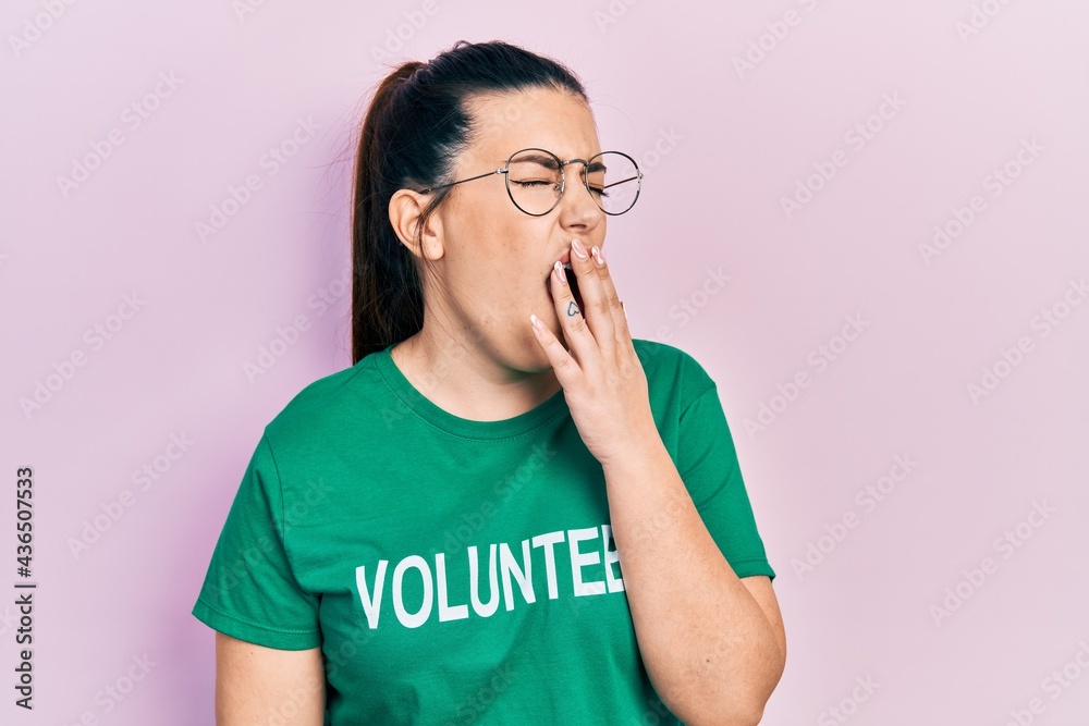 Young hispanic woman wearing volunteer t shirt bored yawning tired covering mouth with hand. restless and sleepiness. Young hispanic woman wearing volunteer t shirt bored yawning tired covering mouth with hand. restless and sleepiness.