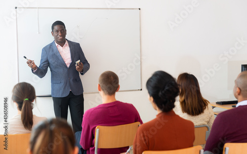 African american male teacher lecturing to adult students