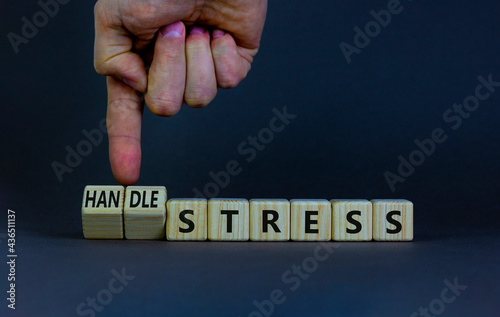Handle stress symbol. Businessman turns cubes and changes words 'stress' to 'handle stress'. Beautiful grey background. Medical, psychological, handle stress concept. Copy space.