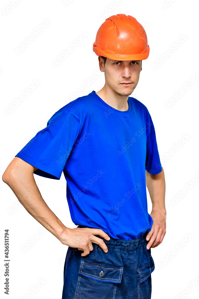 Studio portrait of a confident worker in a construction helmet looking at the camera and holding his hands on his belt. A young guy of Caucasian appearance is isolated on a white background. Studio portrait of a confident worker in a construction helmet looking at the camera and holding his hands on his belt. A young guy of Caucasian appearance is isolated on a white background.
