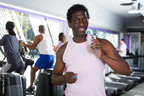 Man with bottle of water in a sports club