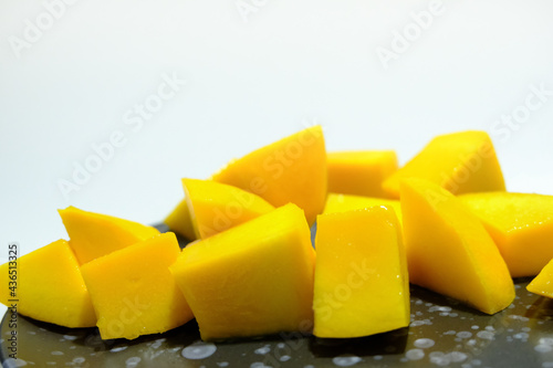 Ripe mangos in a black ceramic dish. photo