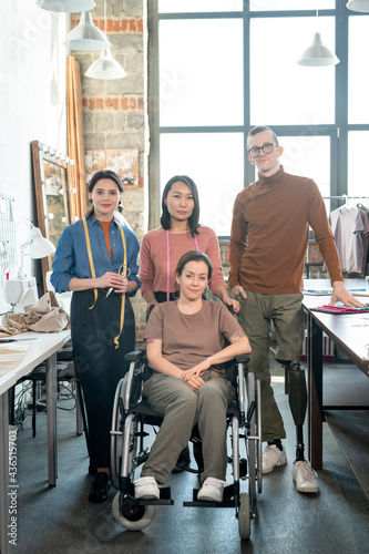 Group of young contemporary fashion designers in workshop