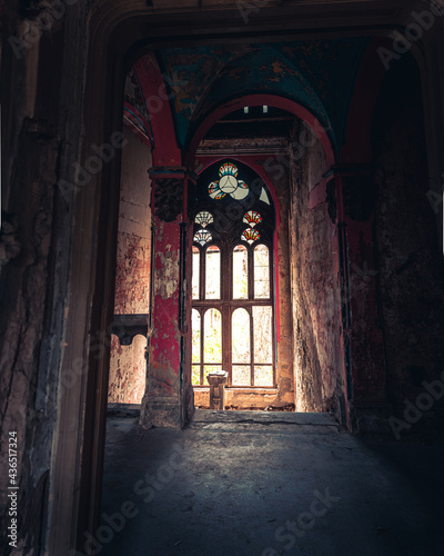 Light coming through a huge window in the spooky Spicer castle in Serbia